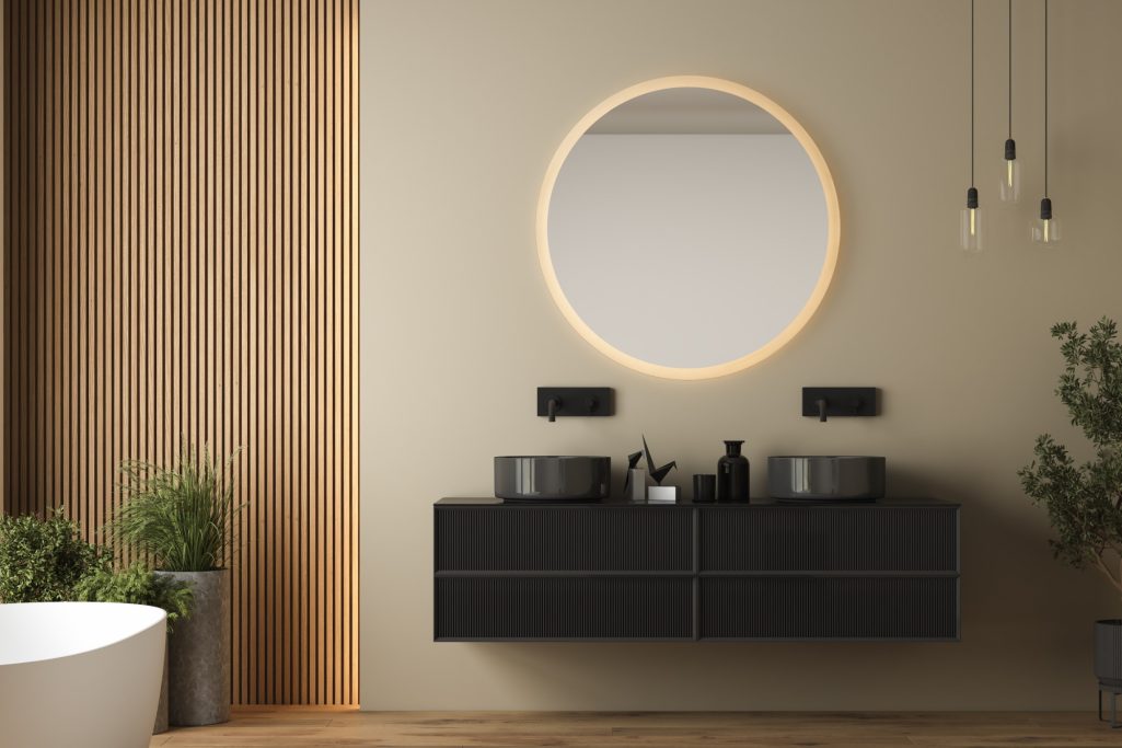 Modern Badezimmer mit einem runden Spiegel und einer eleganten Schrankzeile.